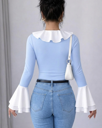 Top noir uni à col volanté et bordure contrastée